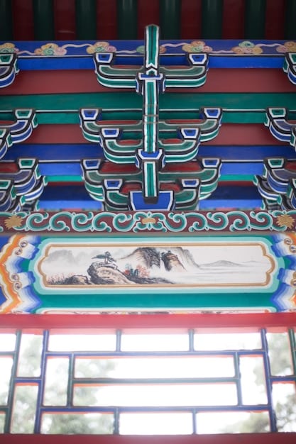A detailed shot of the ornate roof of a building inside Gyeongbokgung Palace, showcasing the intricate Korean architectural details and vibrant colors.
