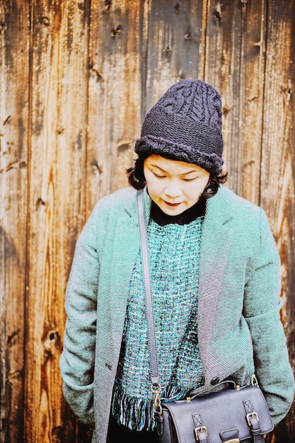 A collage showcasing popular K-drama fashion trends, such as oversized sweaters, pastel-colored outfits, and stylish accessories like berets and statement earrings, next to images of young Americans sporting similar looks.