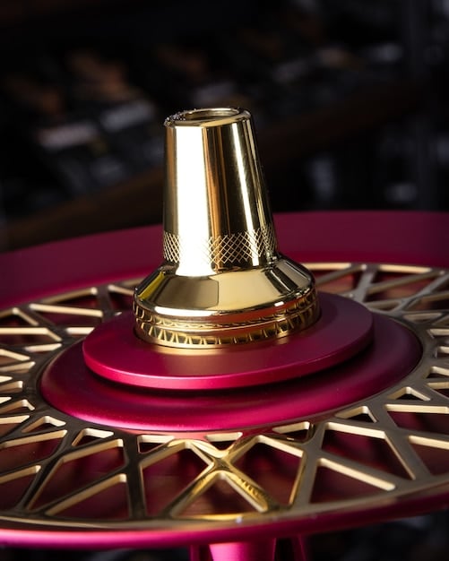 A close-up shot of an award trophy with intricate detailing, placed on a velvet cushion. Soft lighting highlights the trophy's craftsmanship, signifying prestige and recognition.