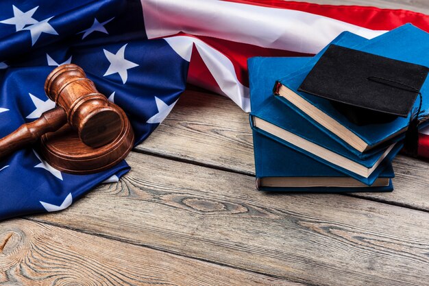 A gavel resting on a stack of law books with the US flag in the background, symbolizing the legal proceedings and potential changes in streaming regulations.