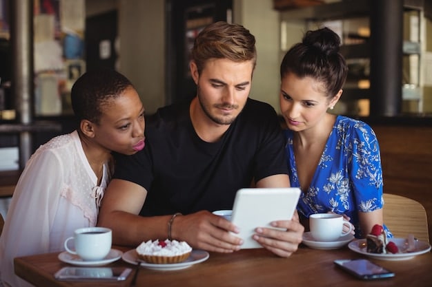 A diverse group of people in a modern coffee shop, each using a foldable phone in different ways: one reading, another video conferencing, and a third taking notes. This highlights the versatility and broad appeal of the device.