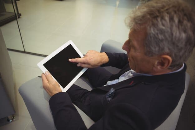 A close-up shot of a tablet showcasing a foldable screen prototype, demonstrating its flexibility and seamless display technology. The background is a tech conference with blurred attendees.