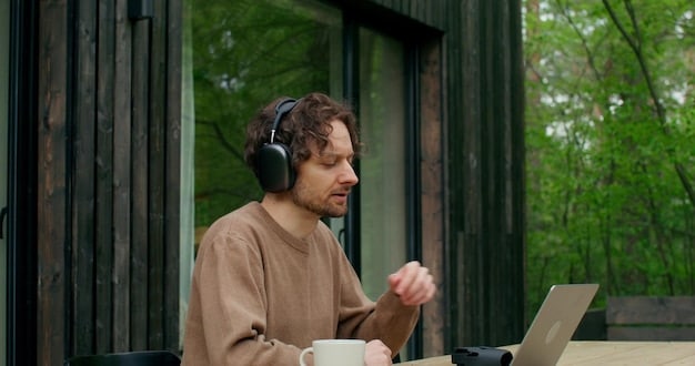 A remote worker wearing advanced noise-canceling headphones while working on a laptop. The background is intentionally blurred to emphasize the focus and concentration of the individual. Soft, indirect lighting enhances the comfortable and productive atmosphere.