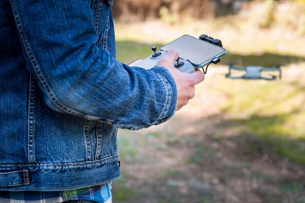A close-up shot of a drone displaying its Remote ID broadcast information on a smartphone screen. The screen shows the drone's identification number, location, and altitude, with the drone visible in the blurred background. The setting is an open field with clear skies during the day.