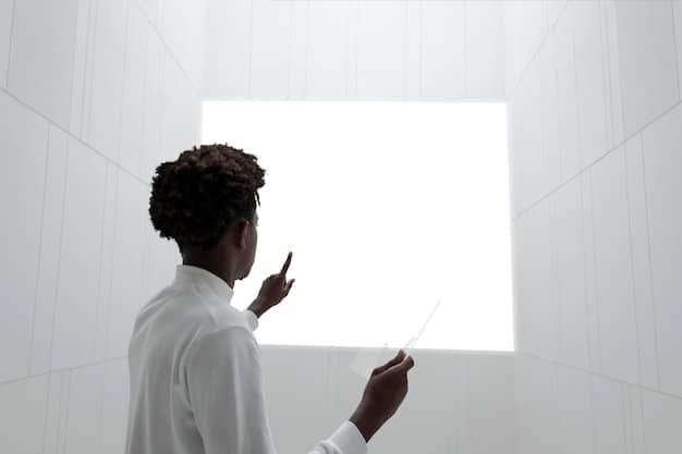A young professional is giving a presentation using a portable projector in a modern, minimalist office. The projector is placed on a desk and projects a clear image onto a white wall. The presenter is pointing to the projected image, and the audience is engaged and attentive.
