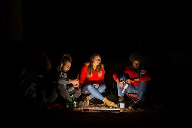 A group of friends are gathered around a camping tent at night, watching a movie projected onto the side of the tent using a portable projector. The projector is small and compact, sitting on a log. The friends are laughing and enjoying the outdoor movie experience. The scene is lit by the projector screen and a campfire in the background.