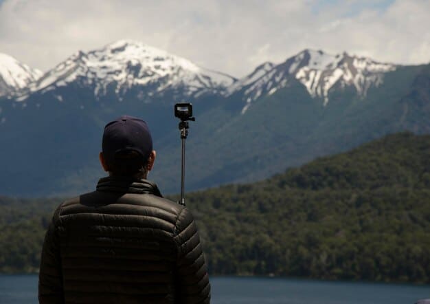 An action camera capturing panoramic footage from a mountain peak, showcasing the vast landscape in stunning 8K resolution. The camera's display shows real-time color grading and HDR settings, highlighting its advanced imaging capabilities.